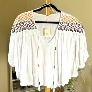 NWT FREE PEOPLE SP Flowy white w/embroidery at the shoulders, w/decorative ties.